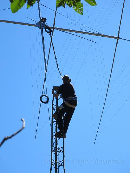 IMG_0660.JPG - Marc getting ready to grab the antenna mast and help guide it into the thrust bearing at the top of the tower.